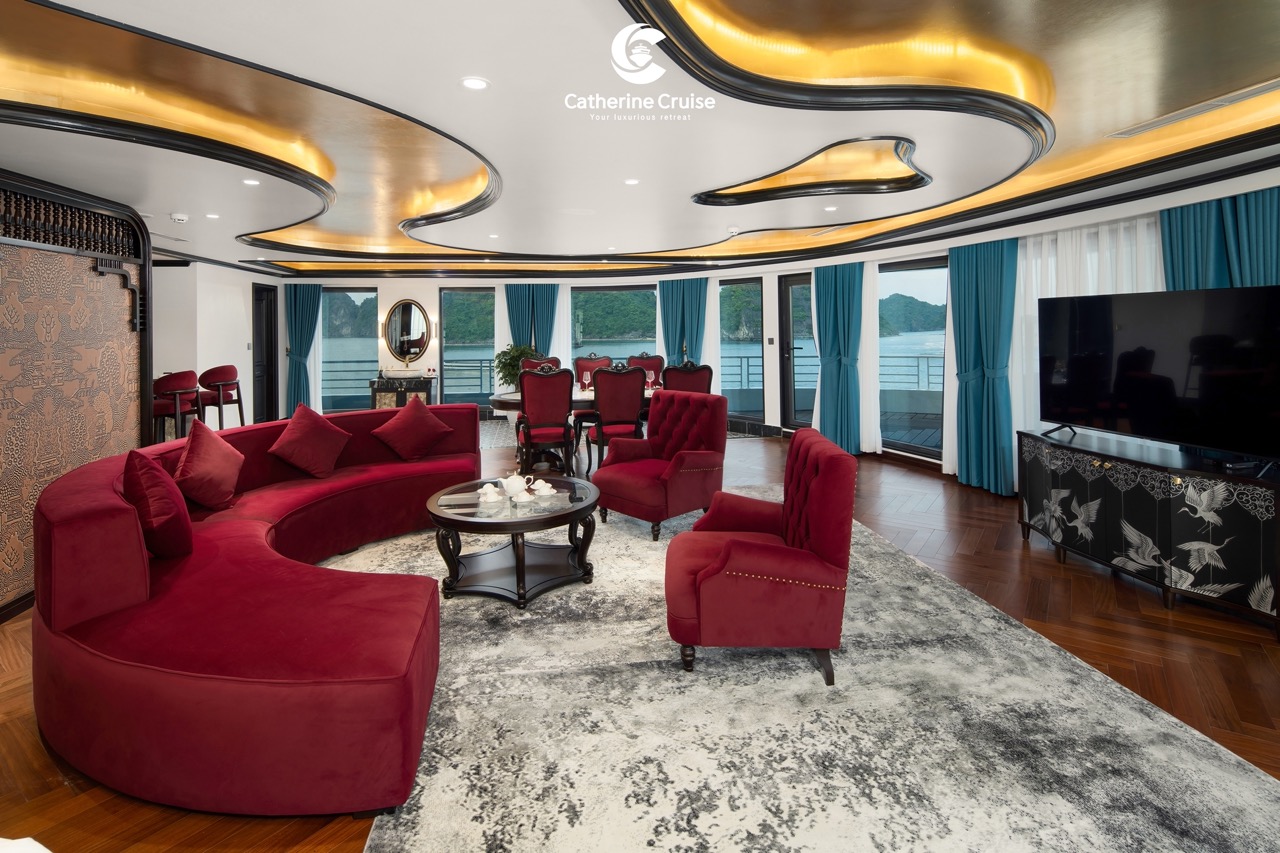 Luxurious cruise lounge with red velvet seating and scenic water views, perfect for relaxation and socializing.