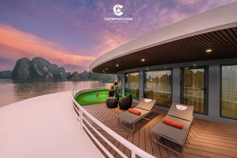 Luxurious cruise deck with lounging chairs and scenic river view at sunset.