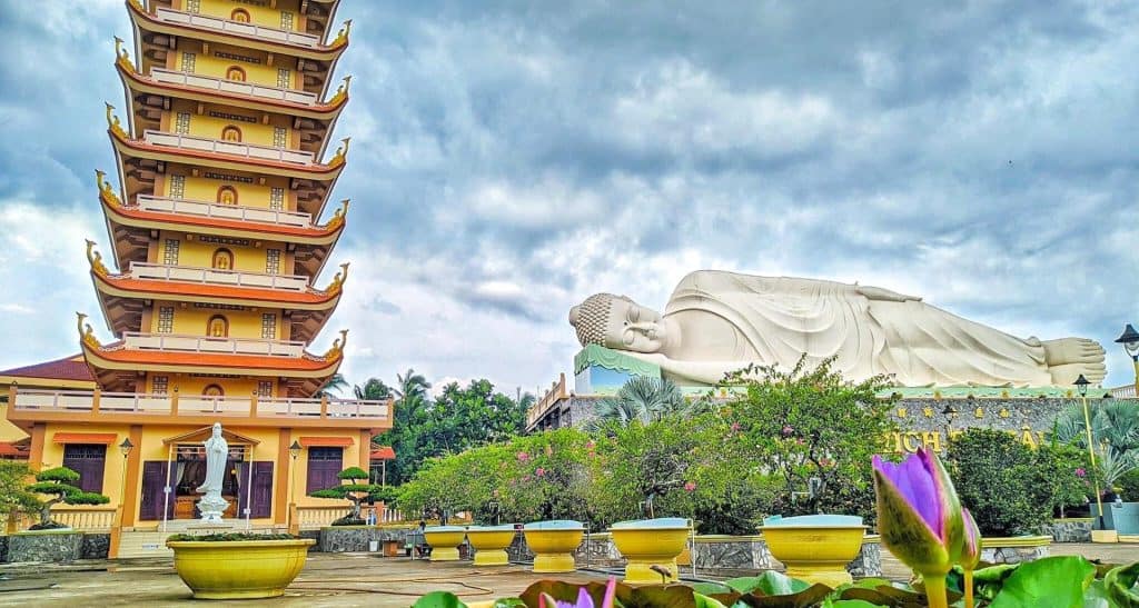 Pagoda and Reclining Buddha Statue in Vietnam's Mekong Delta, a serene spiritual site.
