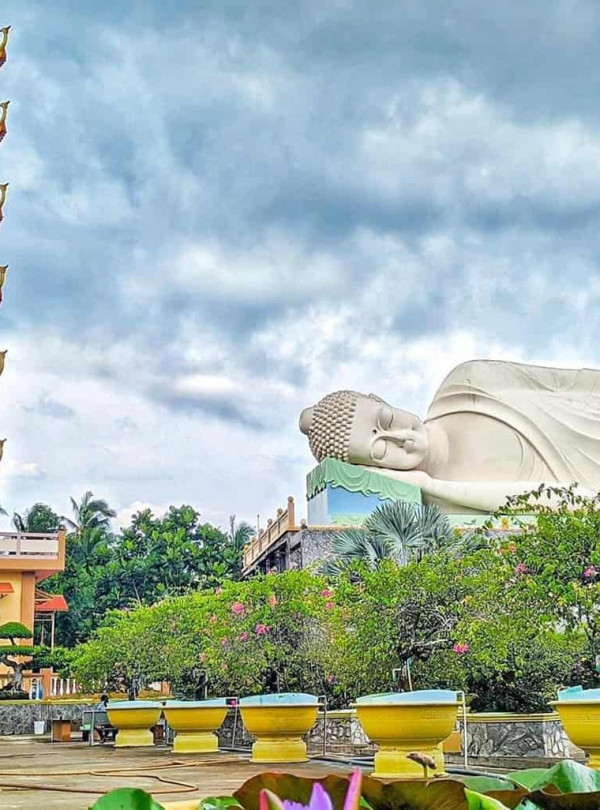 Pagoda and Reclining Buddha Statue in Vietnam's Mekong Delta, a serene spiritual site.
