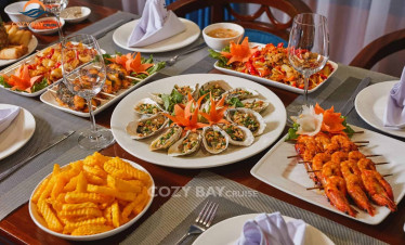 Seafood platter and local dishes on luxury cruise.