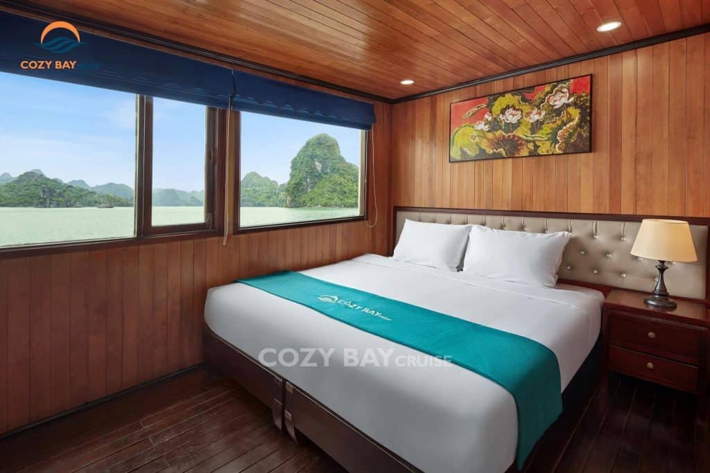 Comfortable cruise cabin with scenic view of Halong Bay.
