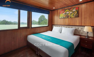Comfortable cruise cabin with scenic view of Halong Bay.