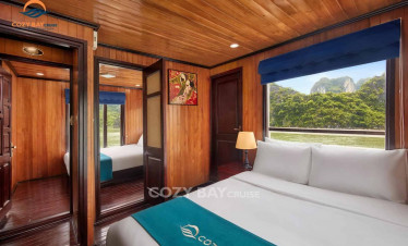 Cozy Bay Cruise cabin with wooden interior and scenic view of Halong Bay.