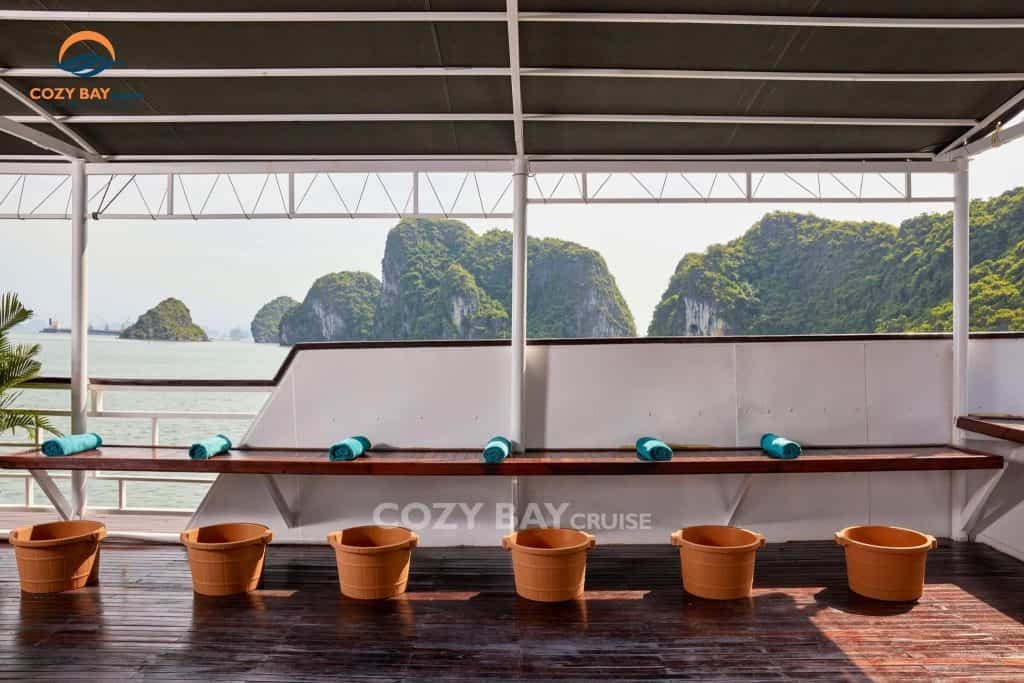 Relaxing deck with scenic views of limestone islands in Halong Bay.