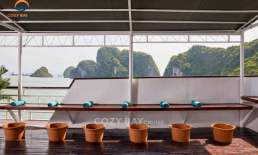 Relaxing deck with scenic views of limestone islands in Halong Bay.