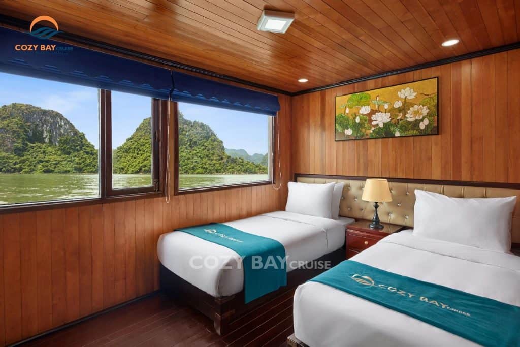 Cozy bay cruise room with scenic view of limestone islands in halong bay.