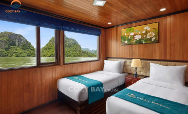 Cozy bay cruise room with scenic view of limestone islands in halong bay.
