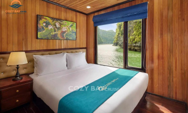 Cozy Bay Cruise room with scenic view of Halong Bay, perfect for a relaxing getaway.