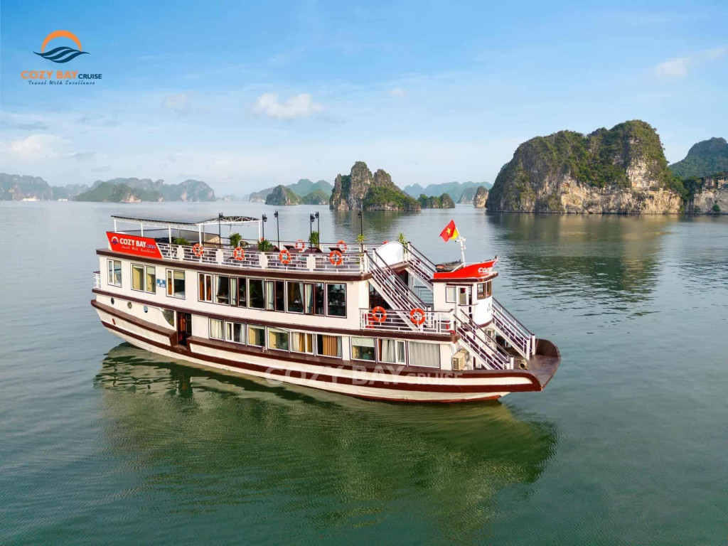 Cozy Bay cruise boat sailing through stunning Halong Bay scenery, offering a luxurious experience on.
