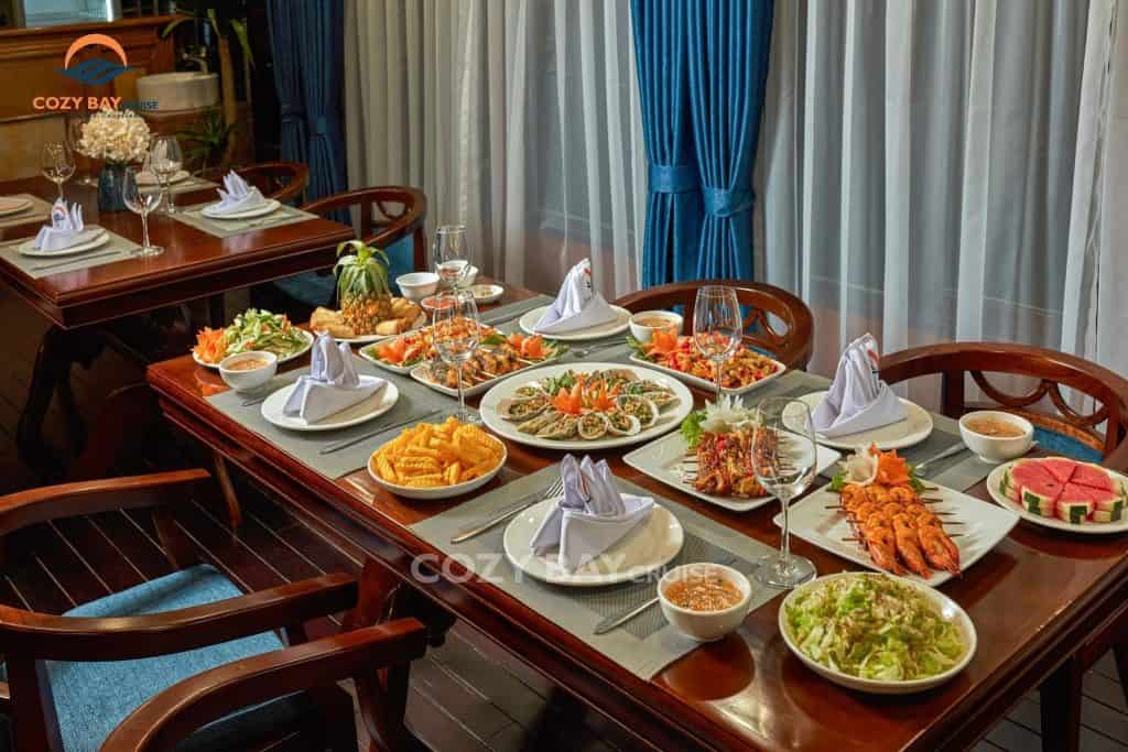 Halong Bay cruise dining experience with a variety of fresh seafood and local dishes.