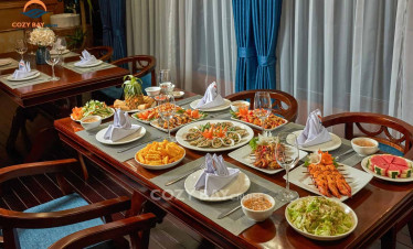 Halong Bay cruise dining experience with a variety of fresh seafood and local dishes.