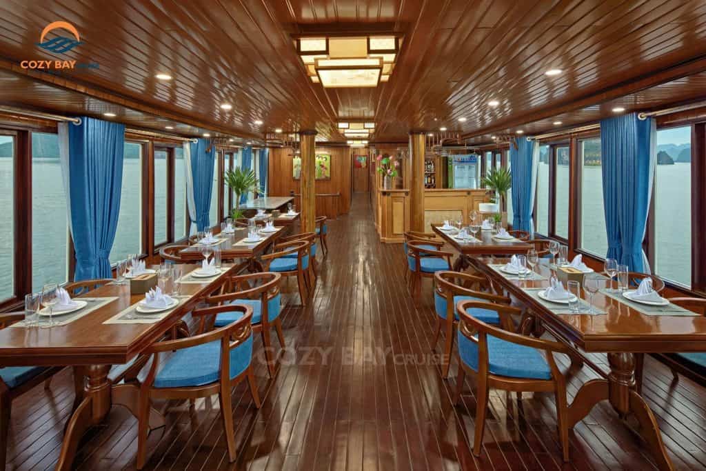 Elegant dining area with panoramic views of Halong Bay, perfect for a luxurious cruise experience.