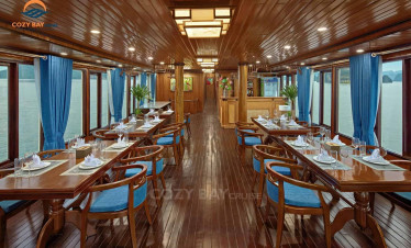 Elegant dining area with panoramic views of Halong Bay, perfect for a luxurious cruise experience.