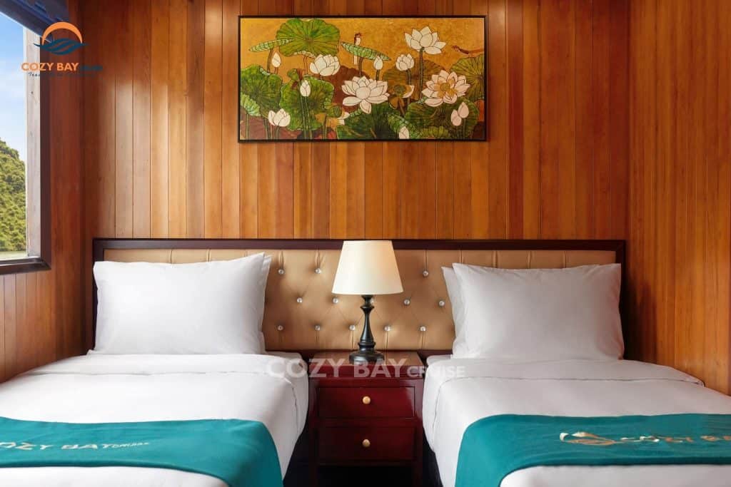 Comfortable cruise cabin with wooden interior and cozy bedding.