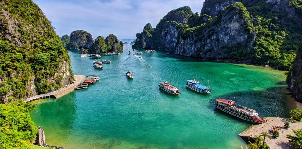 Halong Bay scenic view with boats and lush green islands.