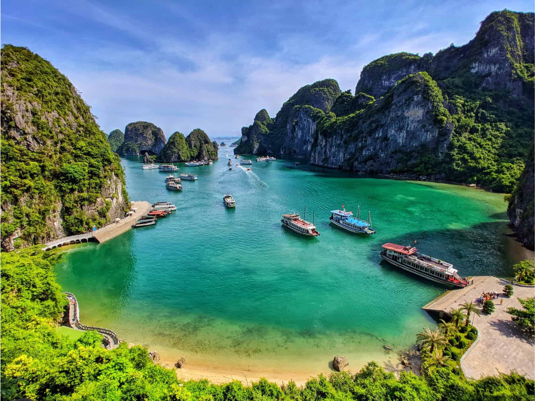 Halong Bay scenic view with boats and lush green islands.