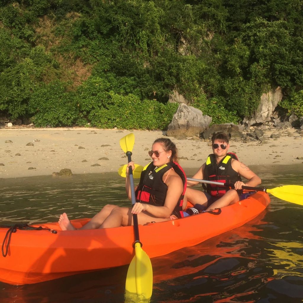 Kayaking adventure in Halong Bay with stunning limestone karsts.