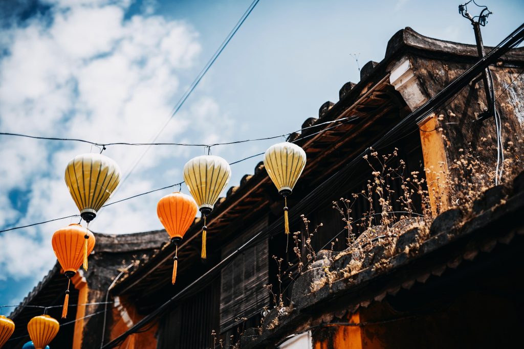 Lanterns hanging along the ancient rooftops create a magical atmosphere in Hoi An.