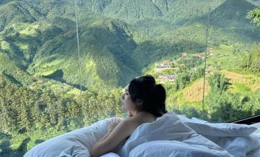 Mountain view of Sapa with lush greenery and clouds, perfect for a peaceful retreat.