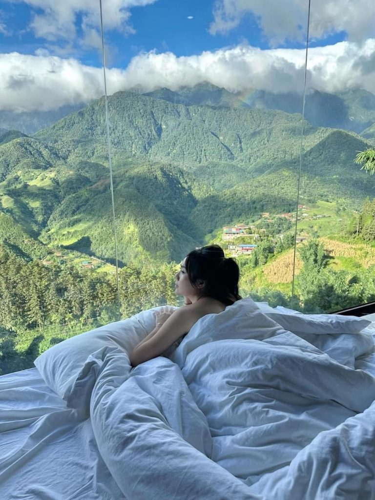 Mountain view of Sapa with lush greenery and clouds, perfect for a peaceful retreat.