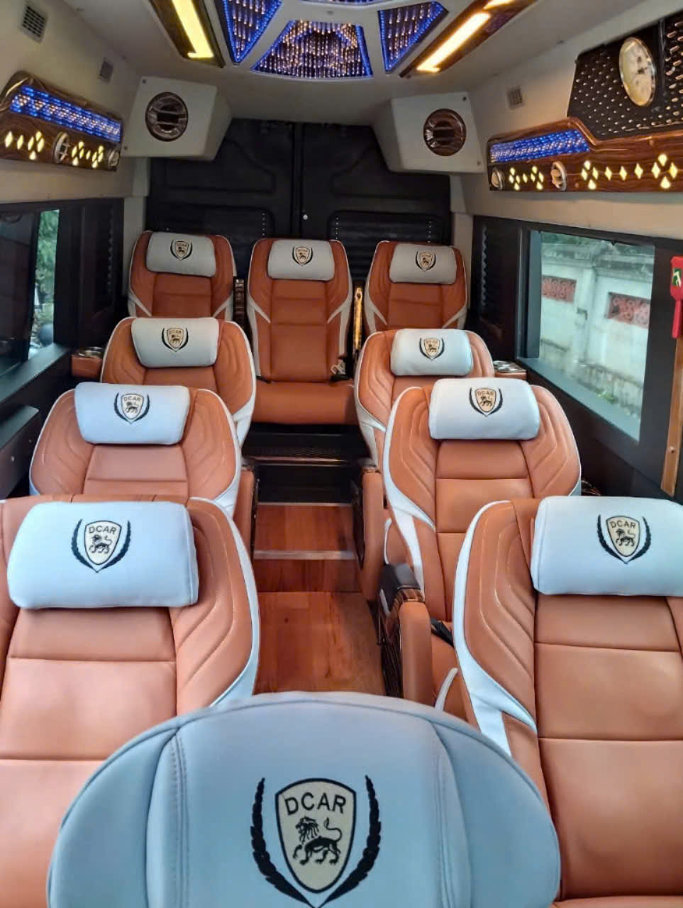 Luxury bus interior with comfortable leather seats and modern amenities.