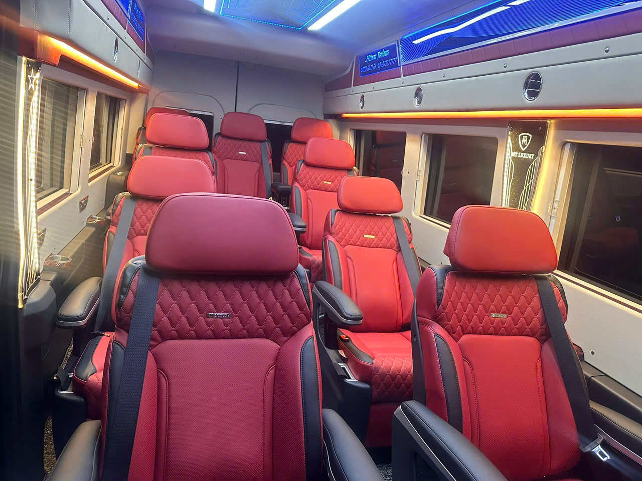 Luxury limousine interior with comfortable red leather seats.