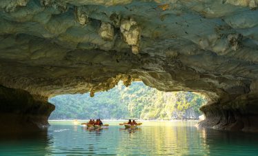 Cave exploration in Halong Bay with stunning natural formations and serene waters.
