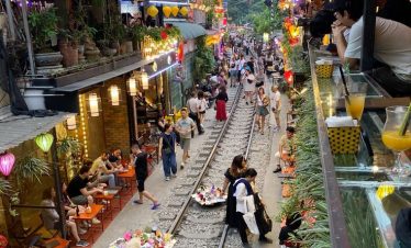 Vietnam street market bustling with vibrant lights and lively shoppers.