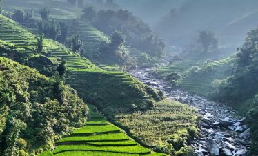 Rice terraces and mountain river scenery in Sapa, Vietnam.