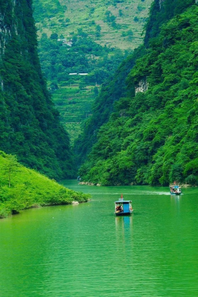 Majestic river flowing through lush green mountains in Sapa, offering a serene and breathtaking land.