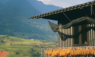 Highland village balcony with scenic mountain backdrop, showcasing authentic rural beauty.