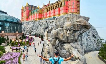 Castle Hill Theme Park attraction in Vietnam with a giant sculpture and colorful castle.