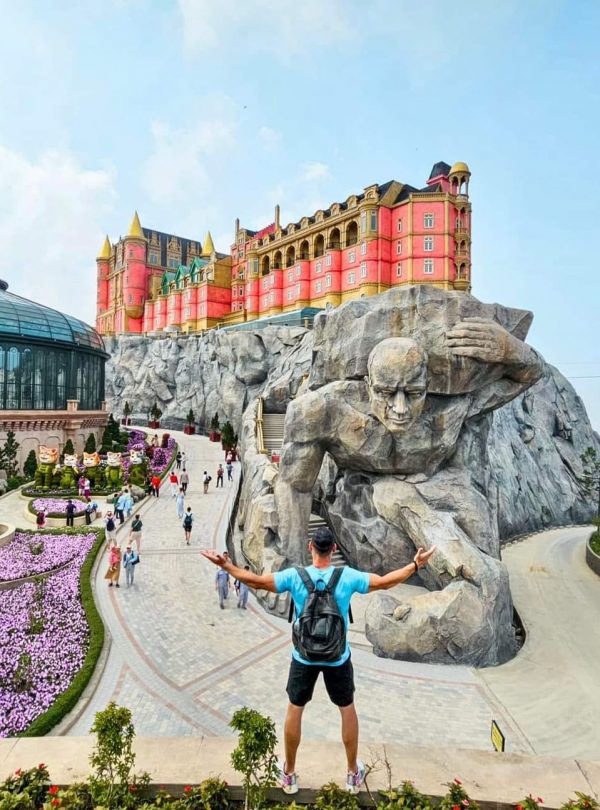 Castle Hill Theme Park attraction in Vietnam with a giant sculpture and colorful castle.