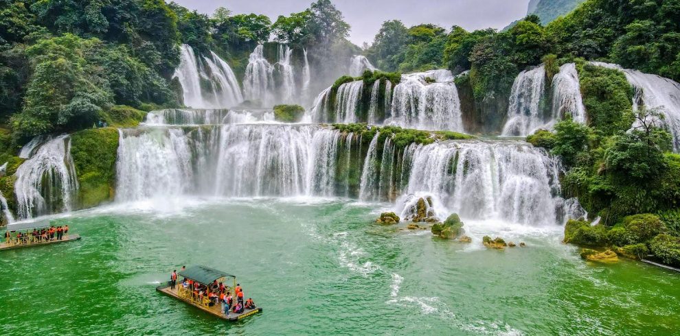 Stunning waterfall scene in Ninh Binh with lush greenery and cascading waters, perfect for nature lo.