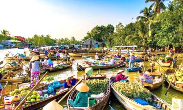 Mekong Deltal Tours - Floating market bustling with vendors and colorful boats on the Mekong River.
