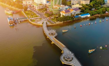 Vietnam cityscape with modern bridge and river views, showcasing urban beauty and vibrant life.