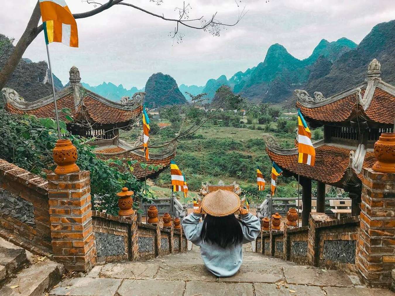 Scenic view of traditional Vietnamese temple with mountain backdrop, capturing spiritual serenity an.