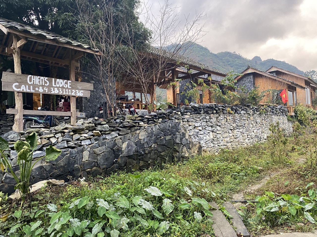 Scenic mountain village with traditional lodges and lush greenery, perfect for exploring Vietnam’s r.