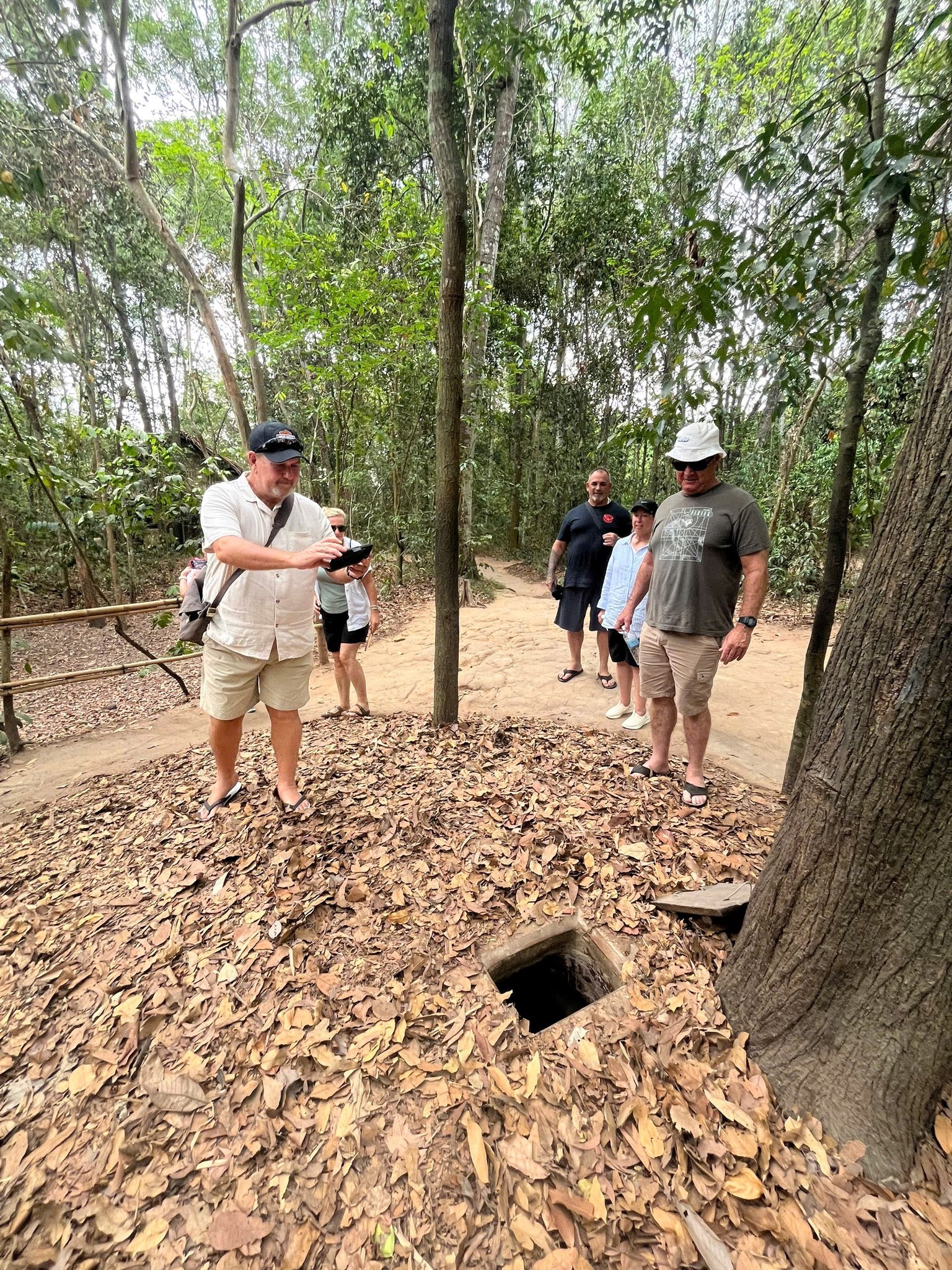 Trekking through lush jungle with a group exploring Vietnam’s natural beauty.