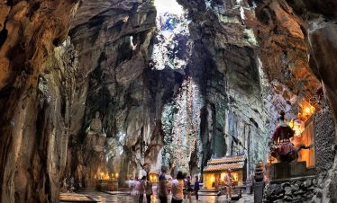 Ancient cave temple with spiritual ambiance, illuminated by soft lighting, offering a serene cultura.