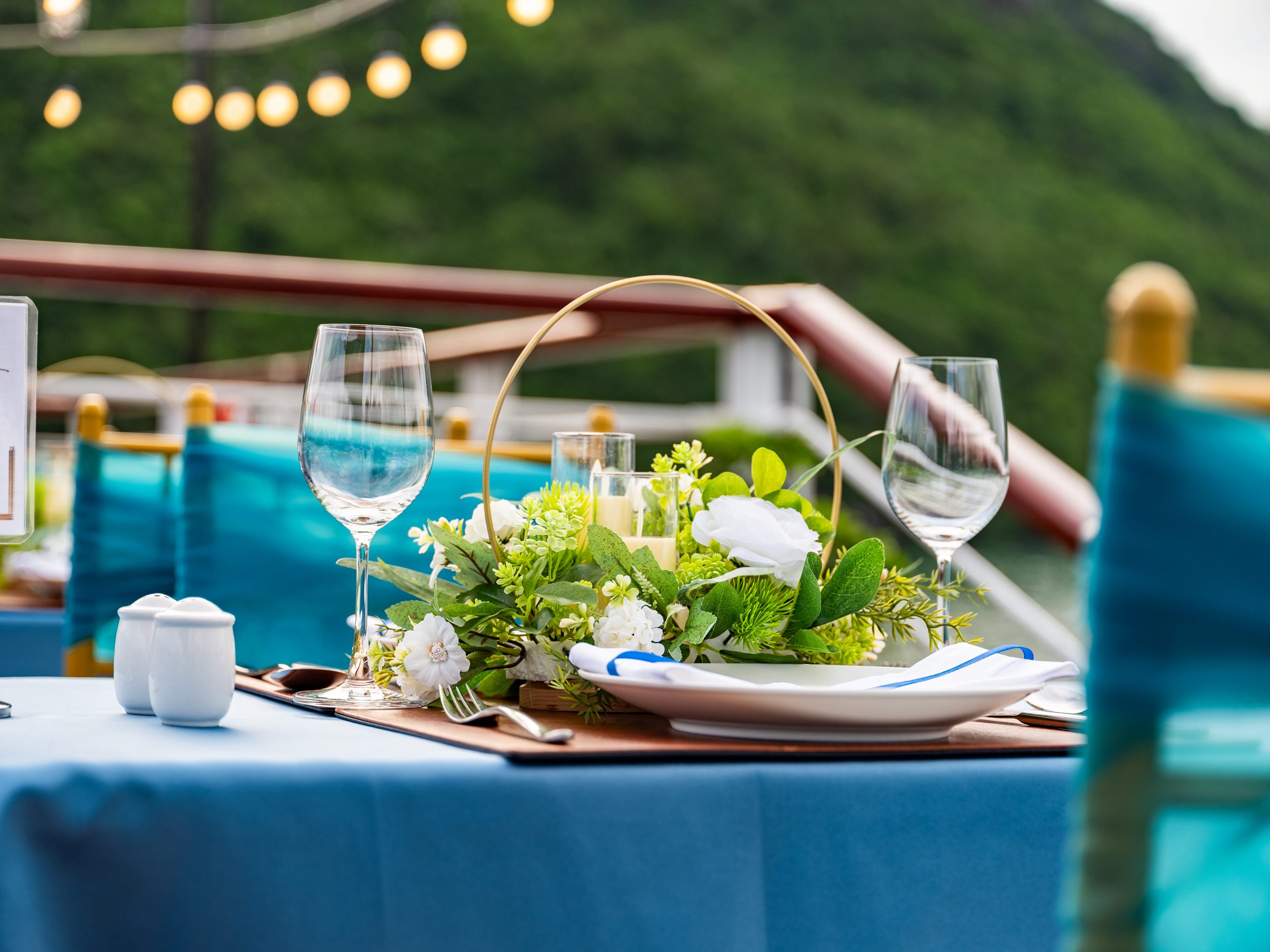 Elegant cruise balcony view of Lan Ha Bay with lush green islands and calm waters, perfect for a rom.