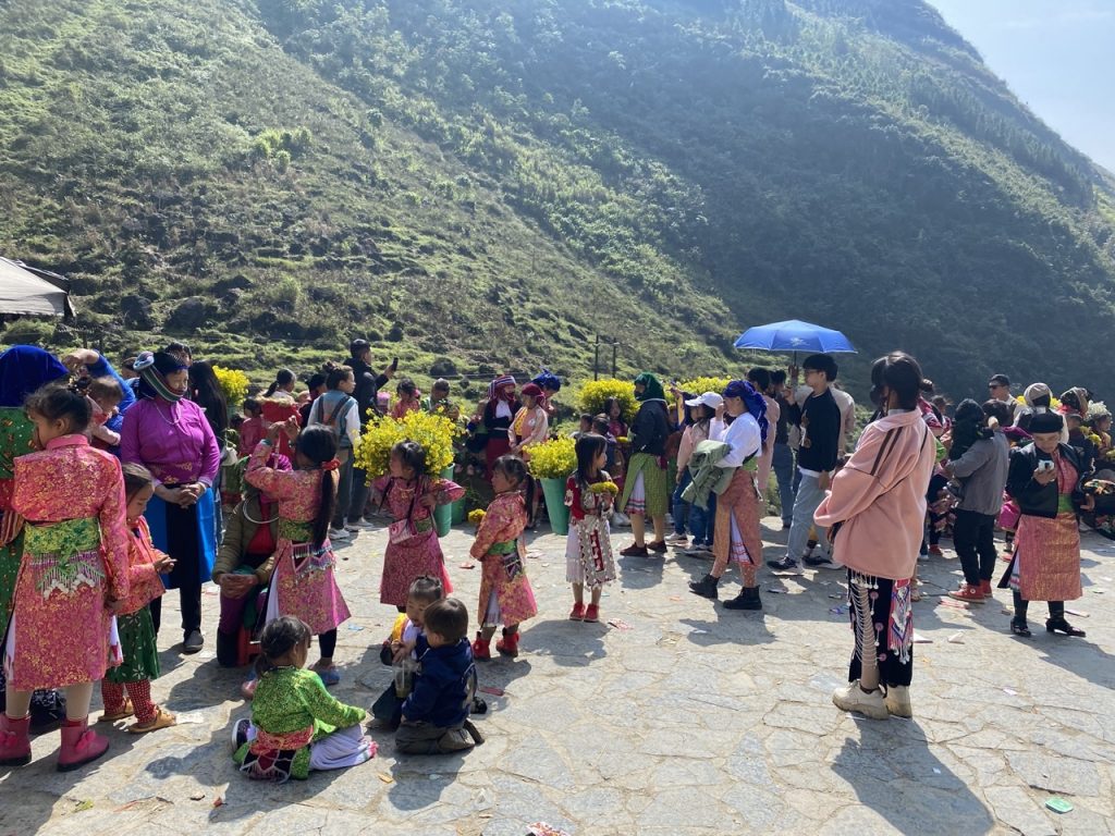 Vibrant local festival scene in Ha Giang with colorful traditional costumes and joyful participants.