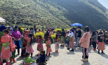 Vibrant local festival scene in Ha Giang with colorful traditional costumes and joyful participants.