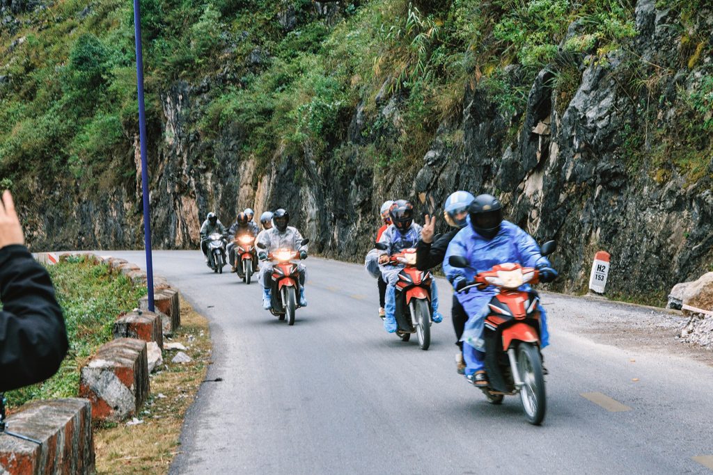 Motorbikes cruising along scenic mountain road in Vietnam, adventure, exploration, travel experience.