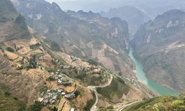 Breathtaking view of terraced mountains and winding roads in Ha Giang, Vietnam, perfect for trekking.
