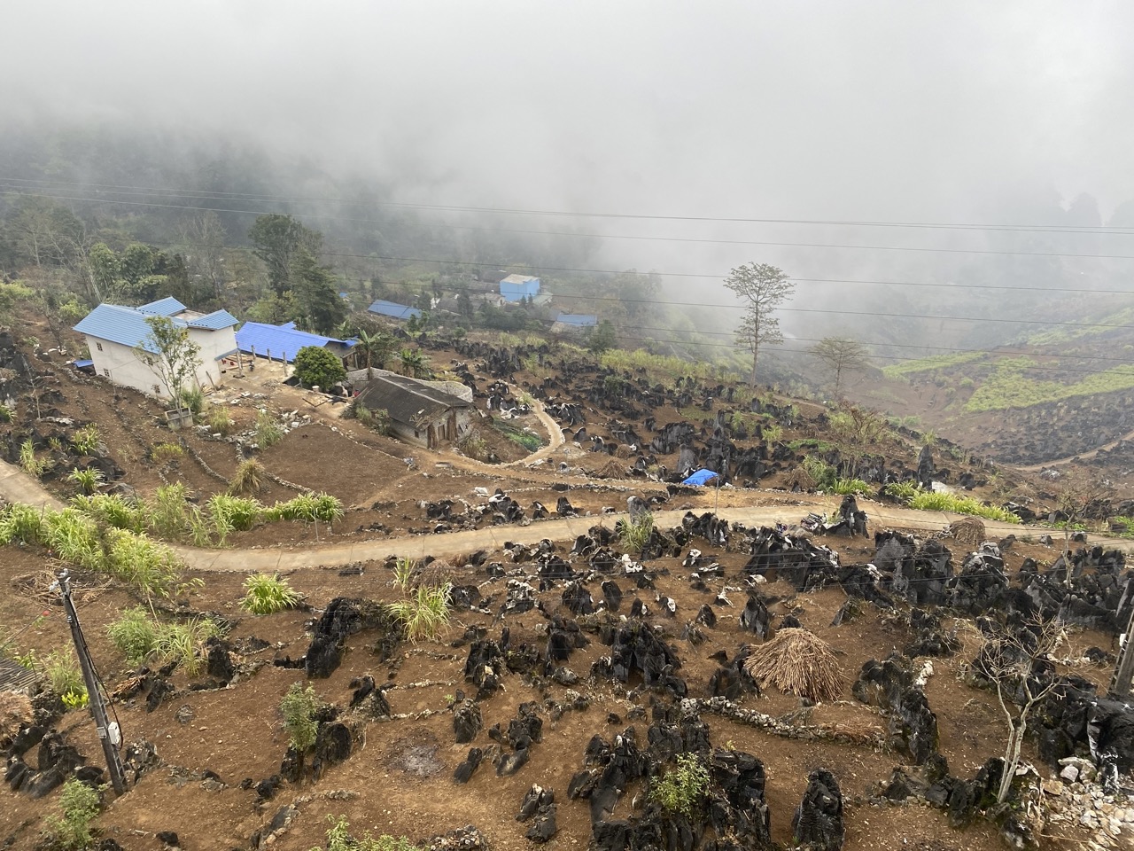 ha-giang-village-rooftops-blue-mist-landscape-viettrendtour