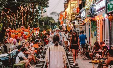 Nightlife and vibrant street life in Hanoi with colorful lights and bustling atmosphere.