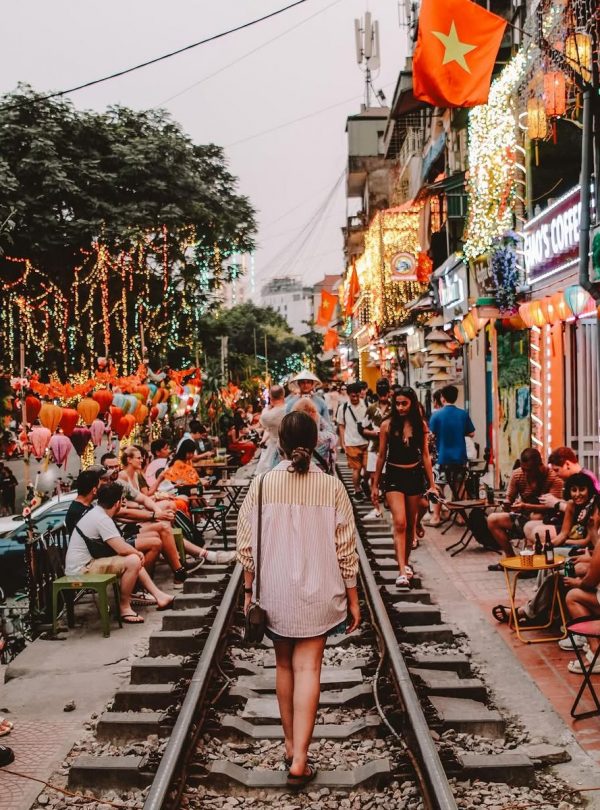 Nightlife and vibrant street life in Hanoi with colorful lights and bustling atmosphere.