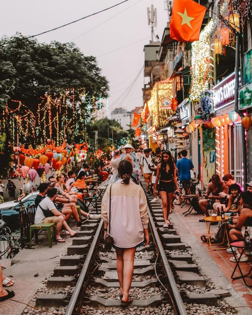 Nightlife and vibrant street life in Hanoi with colorful lights and bustling atmosphere.